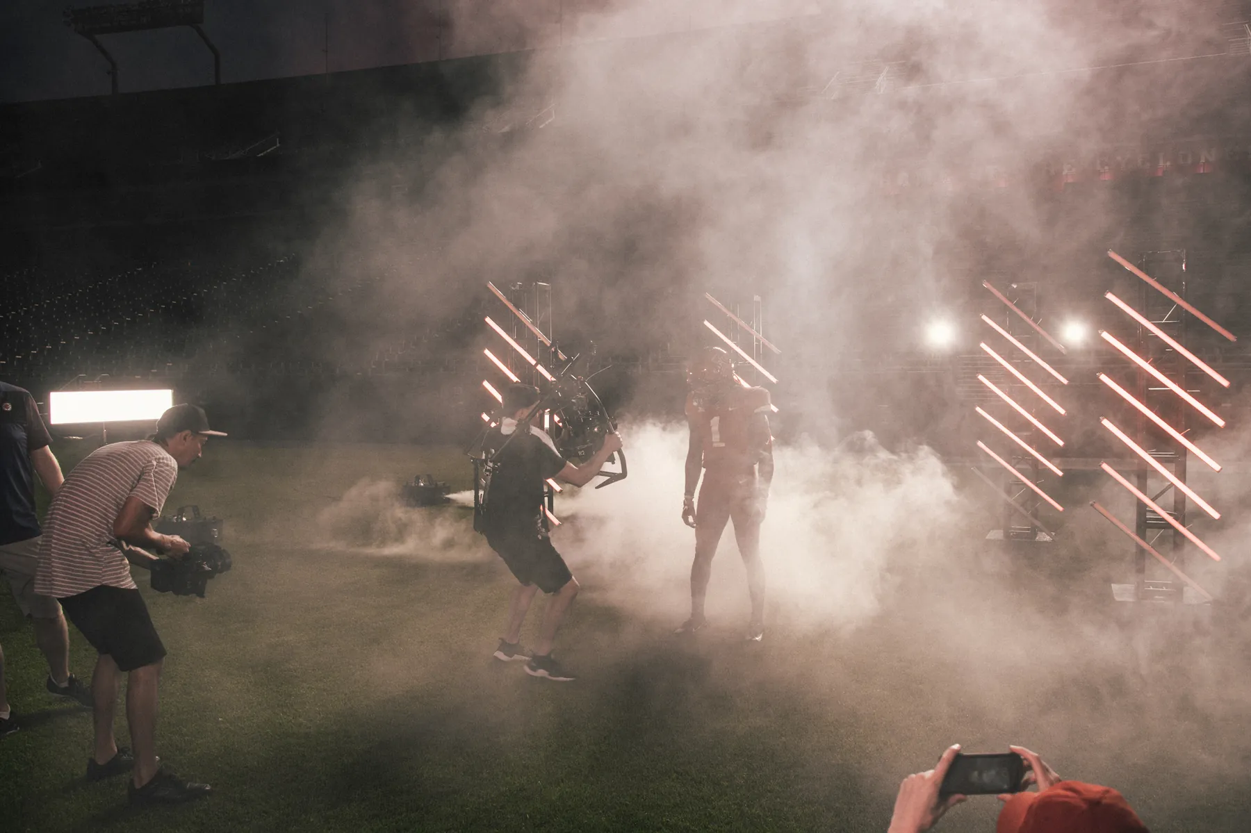Smoke and lights on a football field at night