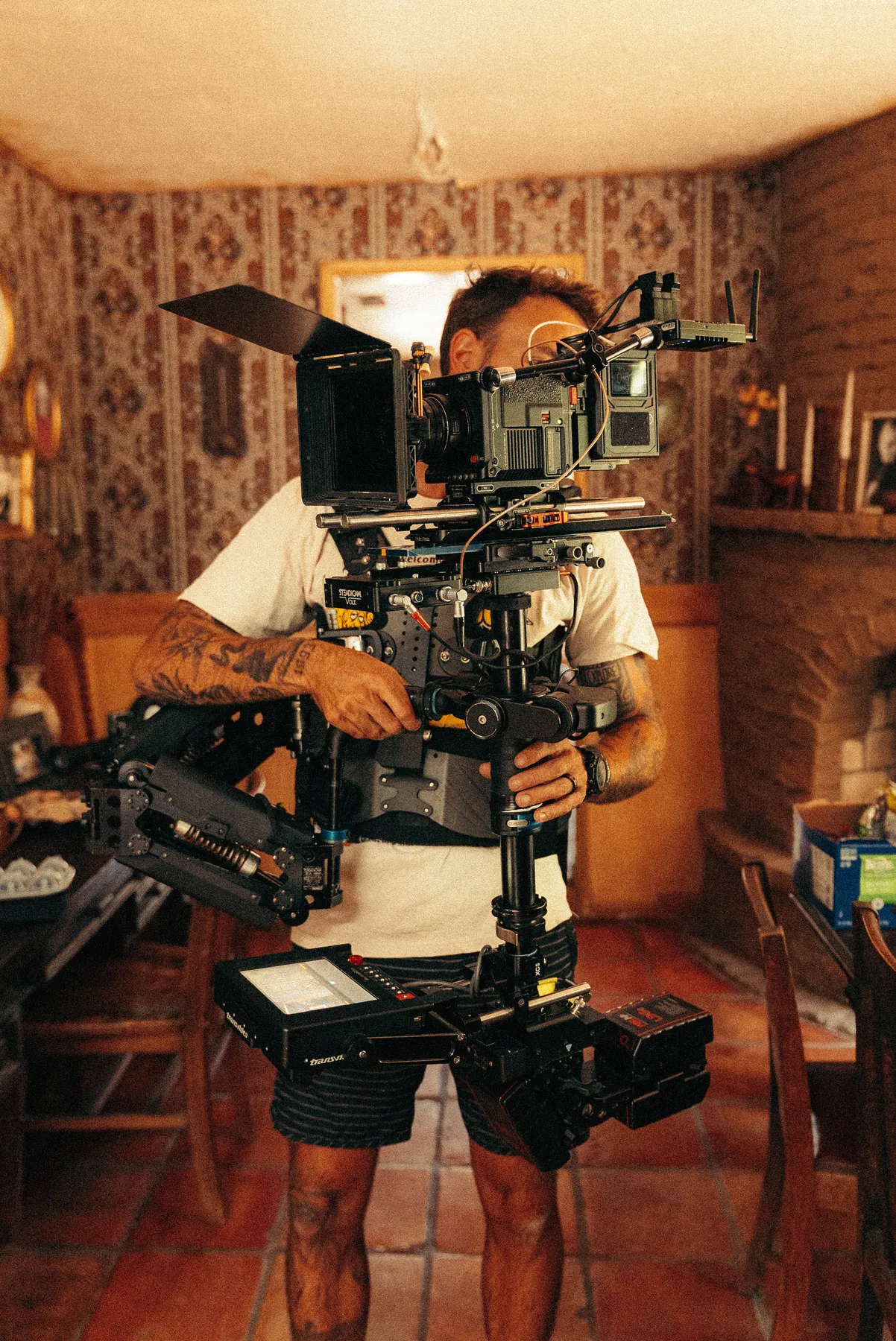 A camera operator working a rig inside a house