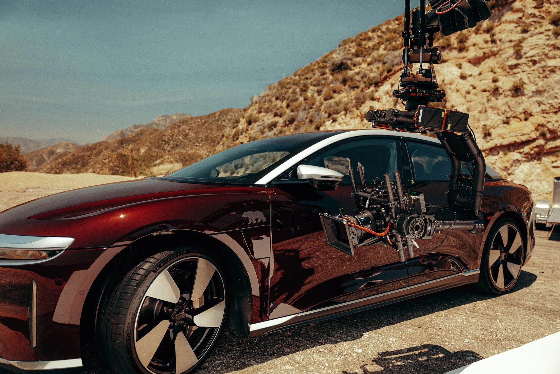 A Lucid Air fitted with a camera rig in the desert