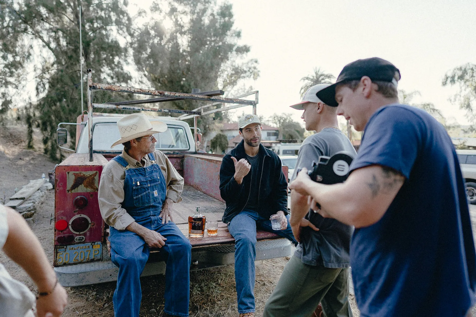 Crew gathered around a truck bed between takes