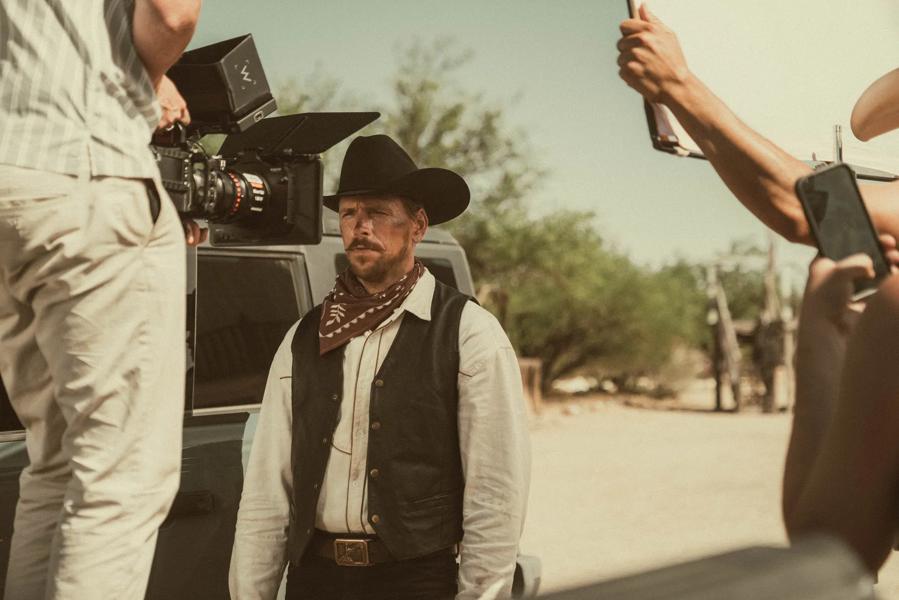 Crew around a cowboy on a western set